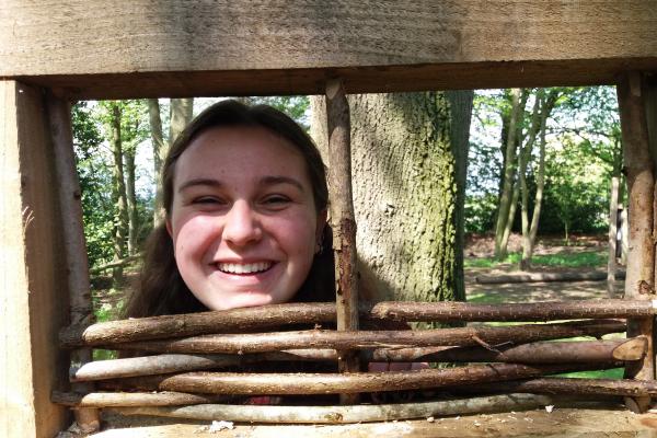 Girl looking through bird hide